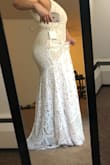 Pros: beautiful lace (nice color too) and an AMAZING train that makes it hard to mistake this as anything but a dress meant to be married in. Lightweight and comfy. I like that it doesn't draw attention to armpit pudge. PRICE! Cons: The front of the dress is kind of basic, but that makes it harder to look ridiculous in. I have a lot of extra room in the bust and stomach (and I've got some rolls). Lace seems impossible to hem, and the front definitely needs it. Slip underneath easily folds, and there's no hiding it. - Kianna G.