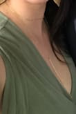 The necklace actually comes in two separate pieces which I thought was kind of nice, so you can wear them individually or together. The choker part was quite snug I have to say, I had it on the loosest setting and it was snug, and I don't necessarily think I have a large neck or anything. Wore it for a wedding with a wrap dress and loved it, the long part especially. The knot is adjustable so can fit the neckline of any dress. - Lauren S.