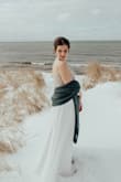 My husband and I eloped this past January, and I hadn't planned to wear a white dress until I found this one. I fell in love instantly, and when I tried it on it fit perfectly. The hemline was too long for me to walk comfortably, so I ended up having it tailored so that we could walk in the snow. I love this dress! - Allison V.