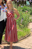 I wore this dress on the 4th of July and received so many compliments. The fit is TTS. If you are a more busty gal its a great dress because you can tie the top in the back more loosely and the straps are adjustable. The dress is lined and has two small slits in the front. The pattern on the dress is very flattering. I have no bad things to say about this dress. Buy It!! - Alexandra F.