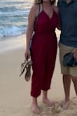Love this jump suit! I was able to wear a strapless bra with it. When I sat down the jumpsuit pulled down in the back and showed my bra. But when standing up the bra didn't show. Great outfit for the price! - Emily W.