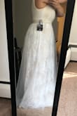 This dress looks like a wedding dress. It's super cute. I love the colors used (white and a pinkish color). Very flattering on and comfortable. Oh, love how pretty the belt/sash is! - Kianna G.