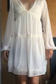 I love this dress. I bought it to wear to my bridal shower. The fabric is breathable and delicate. Inside liner makes the light fabric less see through. Fit is comfortable and relaxed, but it's snug when I try to lift my arms. That's probably to keep the chest from getting loose and slipping off! The front is pretty low so I would have to tape it down or wear a low cut bra under. Over all beautiful dress, and I can't wait to wear it all the time! - Makenna S.