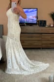 I'm planning my wedding on a tight budget and couldn't justify spending hundreds or even thousands of dollars on a dress that I will wear once. This dress is stunning, comfortable, and so affordable without sacrificing quality! My only complaint is that the slip underneath seems to roll up easily. The little train is an elegant touch. I love it and am so happy with this dress! - Christine M.
