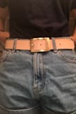 Super cute leather belt in a soft pink color. I got the smallest size possible and it's still a tiny bit big, so I may need to add an extra hole or two. My pant size is a 38 in European sizing. - Lindsay H.