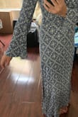 I read the reviews and sized down and it fit great! However, I wish it was better quality. The material is Rayon which is notorious for shrinking. I was very careful while washing it and followed the directions but it still shrunk a noticeable amount. I'm pretty bummed because it is a cute dress but I wouldn't have bought it for this price. It still fits but it's not as flowy and long as the first time I wore it. :( - Jennifer C.