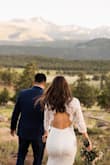 This dress was my dream dress, lace sleeves, open back, just perfection and less than $100. I loved everything about this dress and it was perfect for my Colorado elopement. It did have a little stretch to it but if you have a bigger booty, be prepared to wiggle into it. 
I did have it altered and that helped with the fabric underneath being longer than the lace. I also added a belt from David's bridal and I love that I did that.
The model photos definitely do not do this dress justice and I would highly recommend this dress for elopements or traditional weddings. - Roxana M.