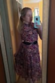 I love the high neck, the midi length, and the flowing material. It looks like it does on the model. But it almost offers so much coverage that it buries the shape of your body if that makes sense. I tried it with a belt and that helps a little. I plan to wear it to a wedding because it is so tasteful I feel like I wont have to worry about any slips or it riding up or anything like that. It's a little large in the neck area on me. Overall though, it's a nice addition to my closet! - Lindsey U.