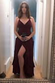 This dress is very beautiful, the material is fairly heavy so it hangs nicely. The wrap style is very flattering and the lace up back is pretty. I found it fit just right, I wouldn't have wanted a smaller size for the small zipper portion at the back to do up properly. - Paige B.