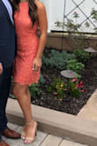 Coral color was stunning. The dress fit perfect. The neckline cut is pretty far so your only bra choice is strapless or sticky bra. Length and fit was appropriate for a wedding. I wore a nude block heel. - Devyn C.