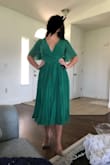 These dress is so cute! The green is beautiful and the fit is great. It moves beautifully and I'm obsessed with the length. I'm still a little confused on the correct way to tie this though since one string seems to be on the inside while the other is on the outside, making tying it a bit weird. - Erica M.