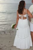 I bought this dress to wear to our beachside 20th Anniversary vow renewal ceremony in Jamaica, and it was perfect! It was the right amount of tastefully sexy without looking inappropriate. The adjustable tie at the top could have been an inch or 2 tighter for me, but the bodice was thick enough to not need a bra and offered enough support. The only problem I experienced was that the lining hung unevenly below the outer layer. I had to pay a local tailor to press out the wrinkles and then cut the layers to hang correctly (I feared tripping on them!?). I only gave it 4 of 5 stars b/c of that needed alteration. - Angela D.
