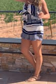 I love this romper and wore it on vacation in Barcelona to wine tasting (I knew I'd be outside and didn't want weird tan lines so the strapless was perfect!) 9 times out of 10 (or maybe even more), I'm a size small- at Lulus and elsewhere. I bought the small first and couldn't get the top to zip the last couple inches though the rest fit perfectly!! Then I bought the medium, which I kept and it fits on, but the bottomed/short part are a little longer and baggier than I wanted, and the seam at the waist line probably has about 1-2 inches of give/extra room, making it look less fitted. It zips now, but with more room than I needs - the inside has that rubbery stuff on it so helps it to stay up but I definitely found myself having to lift it up more often than I'd like. If i'd had the time, I'm not sure I would have kept it. - Katie L.