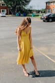 I wore this to a September wedding with a strappy, nude heel and got so many compliments! The material is light and flowy. There are 2 layers, so it's not see-through at all, but you'll want to steam the wrinkles out. The length is perfect. The back is lace-up, so you can adjust it to be looser or tighter around your waist. The only thing to be weary of is the neckline/chest area. My chest is on the smaller side, and I had a few slips throughout the night. I'd suggest sizing up or tying the top higher on your chest, if you have a larger chest. - Amanda T.