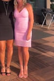 This dress was perfect for a summer wedding! The color was amazing with a tan and the fit of the dress was great! I wore it with a strapless bra, but would also be worn without a bra. Got so many complements on the dress. It's a big right around the legs, but I still was able to dance with it - Lauren M.