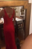 I think this dress is amazing! It has just enough give to be comfortable although it is still form fitting. In the pictures I added, I am wearing a bra and the V in the back goes down juuuuust far enough to see the clasps of the bra in the back. I like the way the V in the front looks much better with my bra on since I have a small chest, so I will either have to rig it to hide the clasps or find a really good pair of sticky bra for the front. I think the Vs are just low enough to still be classy! I also really like the material it is made of - it's not super light but feels thick enough to be durable. For the price, this dress is bomb. I can't wait to wear it to Endymion for Mardi Gras! - Taylor G.
