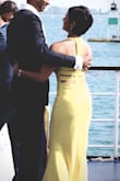 I wore this to 2 different weddings and got a ton of compliments each time, including from complete strangers! This is a non-traditional dress that really stands out in a sea of traditional ones. This light color will highlight all little bumps, so I sized up to avoid a tight fit. I have an athletic build, with broad shoulders and back, but I still got it taken in in the sides and back, in addition to hemming it. But the tummy area fit perfectly. This yellow is stunning, and has got me hooked on the color! Oh, and the back design is amazing! I bought a clear strap bra and had no problems. - Devi T.