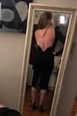 Im by no means a small in anyway shape or form. I've got those lovely lady lumps but after reading all the other reviews I decided to size down. I was NOT disappointed! It fits like a glove and hits your curves like no other. It's a showstopper for sure. So much that I keep trying it on to make sure this is real life! Do I really look this badass! Why yes, I think I do!

The fabric is thick and cozy with plenty of stretch. With a conservative look to the front of the dress, the delicious open back, and curve hugging material you can feel confident and sexy as the divine woman you are! - Lyndsey M.