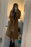 Some of the comments say it runs a little big, but honestly, that's a good thing. This coat is perfect for the winter time and saves some room for large sweaters underneath it. I can wear my thickest sweater and not feel constricted by this jacket. The sleeves are a little long but can be rolled under and you can't tell the difference. Great buy for a great price. Thank you Lulus! - Janine A.
