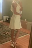 This dress is unique and classy. At first, I didn't know what to think of the one shoulder ruffle, but got used to it. It also photographs well. For fit- usually with stretchy material dresses if it fits my top, it's then tight on my hips. The flare on this dress prevents that issue. - Dana G.