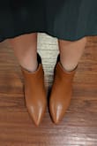 I had to get these when I saw them; I had been looking for some nice brown boots and these are so stylish and unique! They look just as pictured and I agree with some of the other reviews that they are a little tight in the toes - might be good to go a half size up - but they were not so tight that I'm going to exchange them. Will definitely be wearing these a lot this fall and winter! - Karly W.