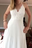 This dress was better than I imagined. Quality and fit. I am having a small wedding and this was the perfect dress for that event. The back is a little lackluster but I decided to add a small rhinestone belt to kick it up a notch. I'm 5'2" and there was plenty of length even if I was 6'2". Again, beautiful dress, highly recommend as a good wedding dress! - Nicole B.