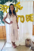 I purchased this dress for my bridal shower. It was so pretty and the quality was great. I am 6' tall so the slit came up rather high on me. When I sat down I had to make sure I adjusted it to lay flat. I am also rather flat chested so it was a little loose there. Besides that the medium was a great fit for me and I'm excited to wear it again. - Kala P.
