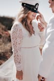 I saw this dress and instantly fell in love. My husband also loved it, and I received and still am receiving ton of compliments on it. It was perfect for our intimate beach wedding. I was comfortable and felt beautiful. I had a tailor add on a beaded belt I found, then she tightened the sleeves, hemmed the dress and the sleeves, and also took the dress in at the waist when I lost some weight. I definitely suggest finding a great tailor if the sleeves are too long or baggy like they were on me. The dress fit perfectly, and is worth every penny. I'm so glad I bought this dress. - Leslie P.