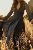 So gorgeous! Wore for my engagement photos and loved it! Fabric is high quality, and a bit on the heavier side thanks to the lining. I am between 5'8" and 5'9" and it was still long enough to graze the ground. Loved the ruffle details on the hem and sleeves! - Trisha A.