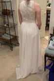 I really like the look of this dress.  I assumed it would be a little too casual for the look I wanted, which it was.  The skirt was heavy and felt high quality.  I could have used an XS size, but only S was available.  I'm sure an XS would have been much better.  The S was really long and baggy on the top and the skirt was pretty long.  I'm short, so most hints I would expect to hem, but bodice would have been harder to alter.  Ordered 5 dresses, ended up choosing a different dress, but this was very nice and SUPER affordable.  Free shipping and return shipping within 10 days is great - take advantage so you can try multiple gowns on!! - Katie P.
