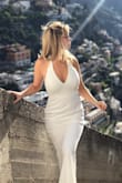 I bought this to wear for some photos before I got married and also took it to Italy with me. It was perfect for what I needed it for. It's a little on the crème side and I would be fine without the lace on top but if you love lace, you'll love it even more! It fits very well. I didn't have time to hem it but I was only using for photos so it didn't matter. I'm 5'3", 113 lbs, 34D/26/36 and purchased a small. - Heather C.