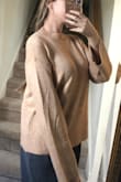 The material is very soft and comfy. It fits exactly as it is pictured on the model. - Emerald B.
