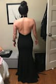 I bought this dress to try on as a bridesmaid option in an upcoming wedding (I'm MOH). The bride didn't end up liking it (didn't want black and wanted a slit), but it fit really well and was pretty comfortable. It definitely fits true to size; however, it was obviously long on me, as I am very short. Additionally, the buttons on the halter strap are a little tricky to do yourself. The fabric is nice, but a little heavy, so I wouldn't recommend it for a hot venue. It was also pretty roomy in the chest area, but I don't have much to work with to begin with. If I had extra money/needed a classy event dress, I would definitely have kept it! - Stephanie D.