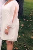 I got a 1X, I usually wear a 16/16W in dresses, 14 in jeans & 16 in pants. I have a wider frame & hips. It was a little too big and I wanted to show off my curves a bit. I ended up getting it taken in on the sides above my hips & up at the shoulders- I'm short, it was too much cleavage for me. If I had more time, I would have exchanged it for an XL. I wore it to an all white event and loved it though- good quality. - Karlie H.