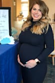 I wore this for my baby shower at 28 weeks pregnant! The perfect amount of stretch. I am normally a small or a medium and I wore this in a small and had plenty of room for my bump! - Jacque L.
