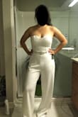 The review I read before purchasing was true for me - felt tight at the top while too loose at the bottom. I expected the bottom to be loose since it's the kind of silhouette I was going for to elongate my legs, but because of the discrepancy between the top part and bottom, I couldn't size up. I was expecting to get these hemmed, but I'm talking about the pant legs being too wide. I think it would work for someone with A/B cups and long legs. The lace on top was beautiful and you can see what it looks like with a bridal belt in my pics! - Jae E.