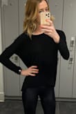 I think this sweater is super comfy and love the way it fits. The zipper in the back is so sexy. I would wash this on gentle cycle and let it air dry. It's started to pill a little bit and the material is very thin. - Amanda M.