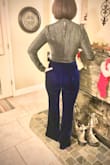 I watched these pants for months and was hesitant to buy them because I'm short and curvy. Finally broke down and bought them and I'm so glad I did! These pants are high quality velvet and fit my curves perfectly. The waist is very high and goes all the way up to my natural 28" waist, above my belly button. It's a side zip waist with a top clasp; the waist band doesn't stretch. I bought the small and they fit my waist perfectly, but I don't have any room to gain weight for sure! The rest of the pants have a stretch to the fabric and look great on my bootie and legs. The legs are very long, so I will either have to hem them or find a super high platform shoe to wear. In the pics, I'm wearing 5" platform heels. - K G.