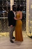 This dress is beautiful! I love the color and the material is nice and thick. I did have an issue with the back of the dress. The back closure is two stretchy cords around buttons and mine were worn, causing the back to not close properly. I was able to safety pin the back without an issue. - Brooke S.
