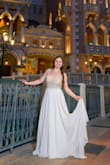 This dress is pretty. I ordered it for my elopement. I am short only 4' 11'' and when I tried on the dress it was extremely long and heavy! I had to get it altered which was fine. She took a lot of fabric off and was able to give it a nice train. The top part fits well, I ordered a size 2. However, while we were taking pictures I started to realize how heavy the dress was. I was constantly pulling it up and it got very uncomfortable. The back is a V shape and it doesn't feel as snug as I would have hoped. Overall I rate this dress a 3, it was ok. - Tianah S.