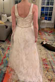Save yourself the time and trouble of ordering this dress. As a wedding dress, it's awful. Cut was not flattering on me in either the front or back. The sheer overlay feels scratchy and cheap and adds an unflattering bulk to the lower half. - Alison M.