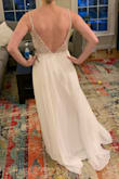 The beading on the bodice is beautiful and the sequins make it much more sparkly in person than it appears in photos. The skirt fabric feels lovely and luxurious and flows gorgeously. The bodice is a bit stiff in the straps and somewhat uncomfortable, and it was a bit too much boob for my wedding venue. The gap between the top of the bodices and chest is quite noticeable and bothered me somewhat. But it would be lovely for a swanky evening event, and I loved how flattering it was. If it had been more appropriate for my event (perhaps thicker straps and slightly more chest coverage), I would have kept it and had it altered to fit perfectly. - Alison M.