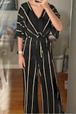 This is the best jumpsuit I own! The material is extremely comfortable, and flowy. Perfect for dancing! The pant-legs touch the floor, which is what I prefer. Could even wear heels with it without being short. And it fits like a GLOVE. The top holds everything in perfectly without being too revealing. I would recommend this to anyone! - Allison M.