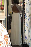 I purchased this in an XS as a potential wedding dress and it runs true to size. I really loved the sleeves and open back. I didn't find the style in the front flattering so I returned it. - Angell