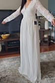 The back is drop dead gorgeous. Runs really large so I would order 1-2 sizes down. Sleeves aren't fitted to arms, they're more roomy. - Stephany S.