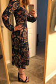 I've been waiting months for this to finally come back in a XS and I finally grabbed it. There was literally one dress left and it was an XS when I checked on it. Meant to be! Yay! I'd ordered this previously in my regular size small even though the reviews mentioned it running large. They weren't wrong. It fit, but it wasn't very flattering. I almost kept it anyway because I liked the dress so much but I'm glad I decided to return it and hope that an XS would come back in stock. The XS is PERFECT. Literally, zips right up and hugs me just right. There is no stretch in this fabric so it's a dream that it fits so well. The fitted waist makes it so flattering with the fluffier sleeves. The fabric isn't as expected, it almost has a crepe texture to it but it's fine. The colors are so vibrant and fun. It goes so well with my red hair. I can't wait to have a chance to wear it! - Jenna F.