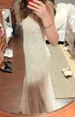 I love this dress so much! The color and detail are beautiful! This is my wedding dress! I ordered this dress in different sizes and I ended up going with the small it fits me snugly but that's what I was going for. The beading is so gorgeous and they have an iridescent shine so even though the dress isn't super white, it is shimmery due to the beading. It's unique and totally what I was going for :) I will have to get it hemmed because it's a little too long in the front for me and I plan to use 1.5 inch heels but for higher heels it might be ok as is. - Angelica B.