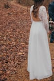 This dress was all I ever wanted for our outdoor winter wedding. I am still getting compliments on it two months later- it's a beautiful material, unique style, and so flattering! I bought a Medium, and it fit perfectly around the waist and bust. However, I did have alterations for tightening the sleeves, tightening where the lace connects to the skirt on the back, and taking off some length. It was totally worth it, as I paid less for this dress+alterations than I would have for another dress alone anywhere else. 
If you are looking for a wedding dress for a small wedding, outdoor wedding, elopement, or literally any event, this is your dress.
Tips: must get a cup-only sticky bra if you plan on wearing one, hair looks good up or down with this dress, and your entire back will be exposed.
Below are photos taken by my wedding photographer, Christina Cerda Photography, that I've cropped to show the dress. - Bethany P.