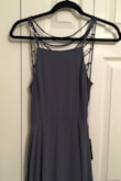 I had to sacrifice the rights to my first born son to get myself out of this dress, but it was worth it because the back is just so cute! You have to spend some time undoing the back of the dress to get into and someone will need to lace it back up for you. I added the padded inserts from an old sports bra of mine into the top and it was snug enough when tied to hold them in place for the coverage I needed. The dress is very long and most everyone should expect to have it hemmed. The material and layering is high quality. It arrives wrinkly which can be helped some by steaming it but I think it won't still be noticeable when the dress is on. - Ashleigh F.