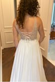 This dress fits me like a glove and it easily looks more expensive than it actually is. Beautiful bead work and the lace-up back is so romantic. Contemplating adding a petticoat underneath to add a little more volume but honestly, it's beautiful as-is. - Netalia S.